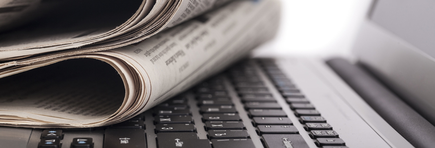 stack of newspapers on a computer