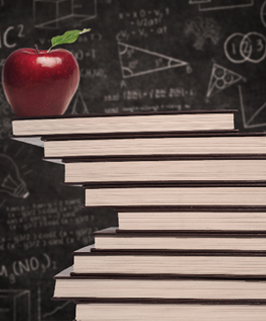 red apple on a stack of books