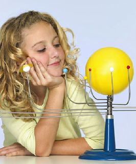 girl looking at model of the Solar System