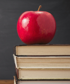 red apple on stack of books