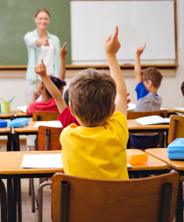 students with hands raised